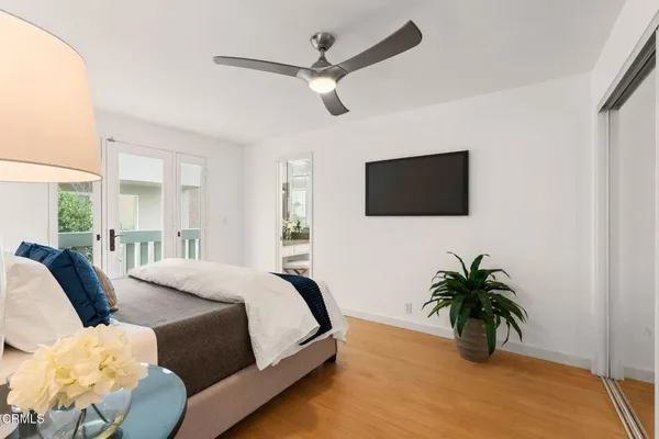 a bed room with a bed window and a flat screen tv