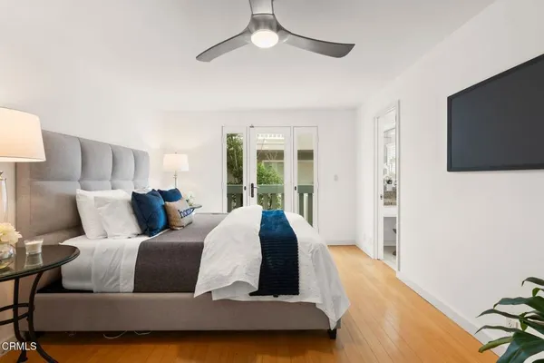 a spacious bedroom with a bed and a large window