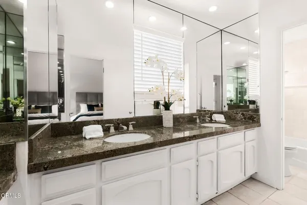 a bathroom with a sink double vanity and a mirror