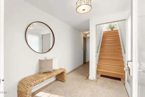 a living room with furniture a large window and a fireplace