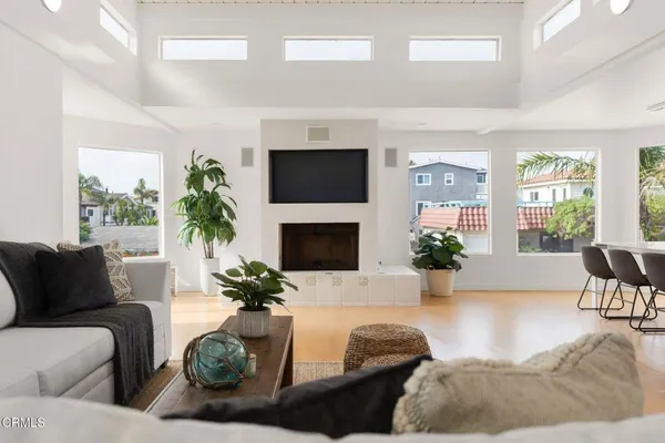 a living room with furniture a flat screen tv and a fireplace