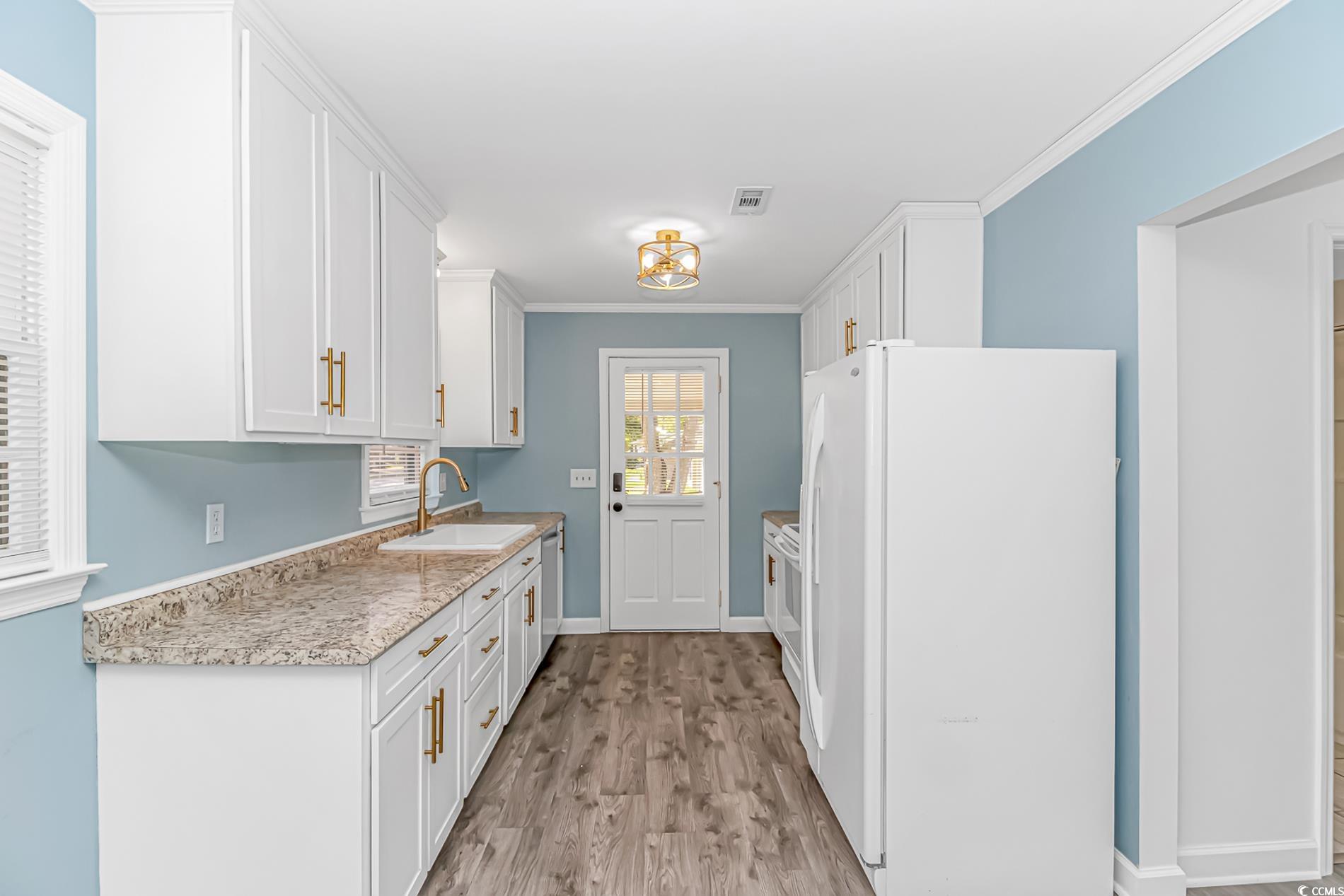 1931 Jasper Street Georgetown, SC 29440 - Photo 11 of 30 Kitchen featuring light wood-style flooring, white