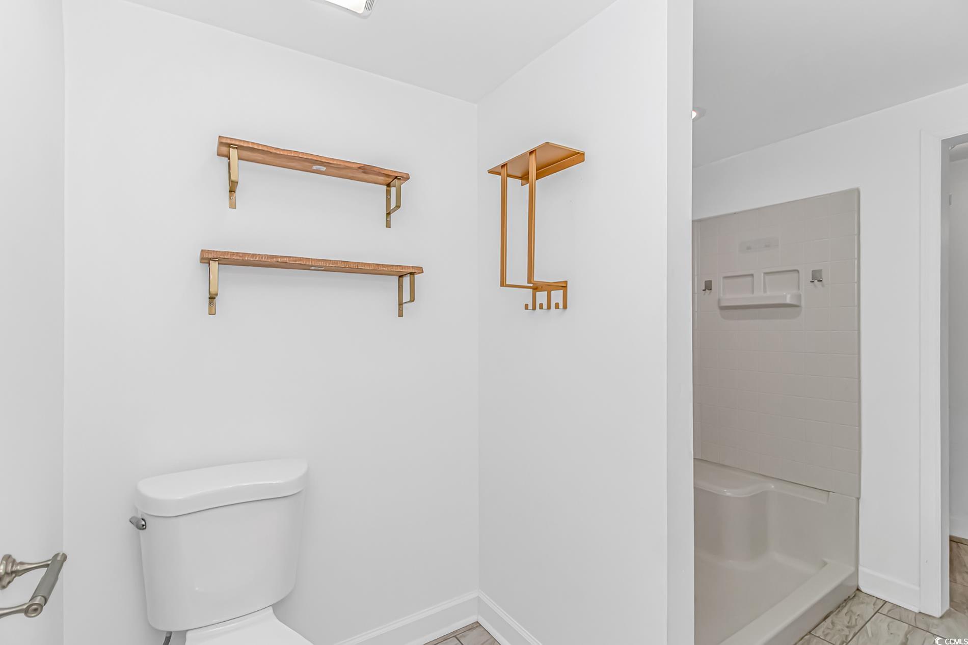 1931 Jasper Street Georgetown, SC 29440 - Photo 27 of 30 Full bathroom featuring a shower, toilet, marble f