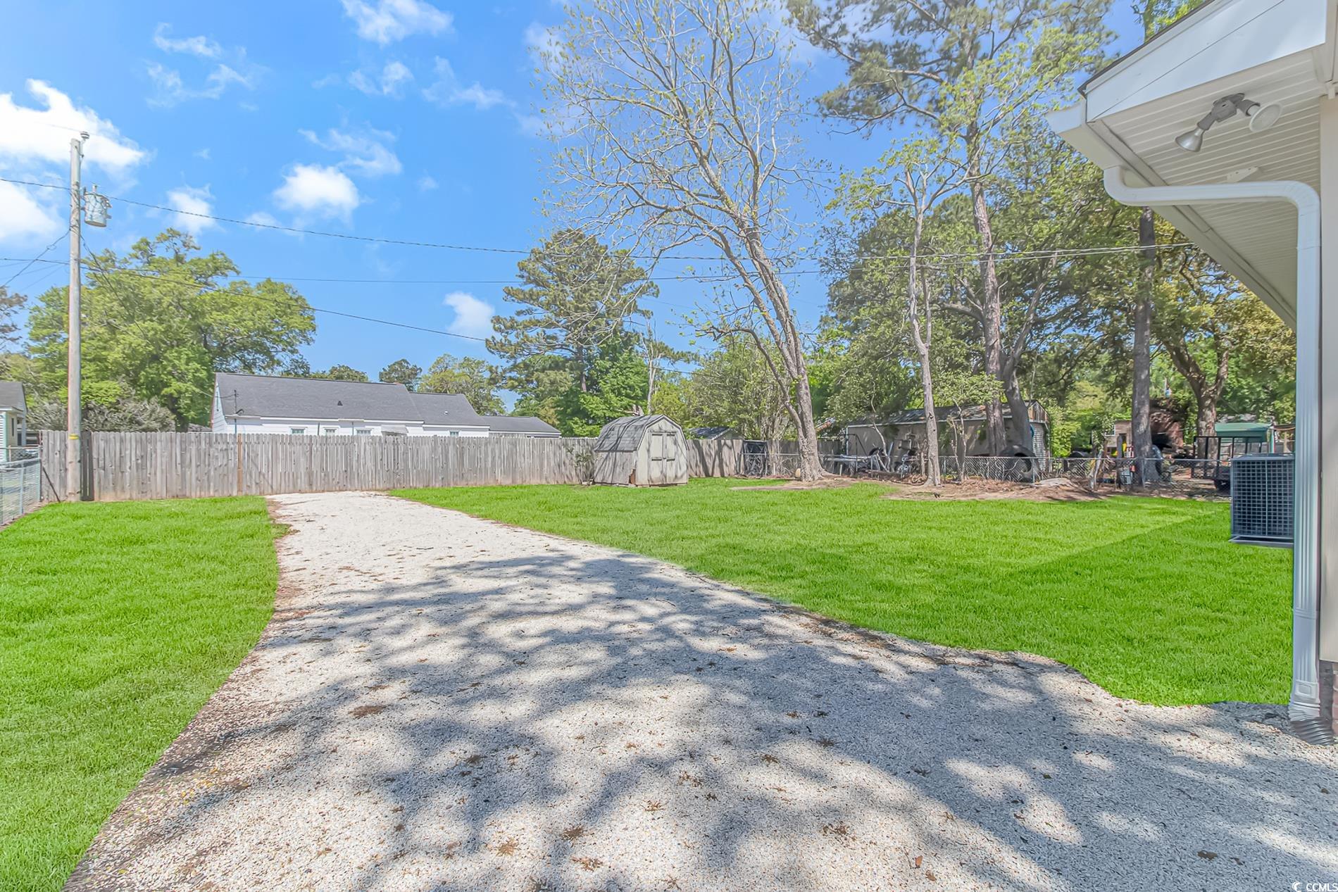 1931 Jasper Street Georgetown, SC 29440 - Photo 28 of 30 View of yard featuring a storage unit, a fenced ba