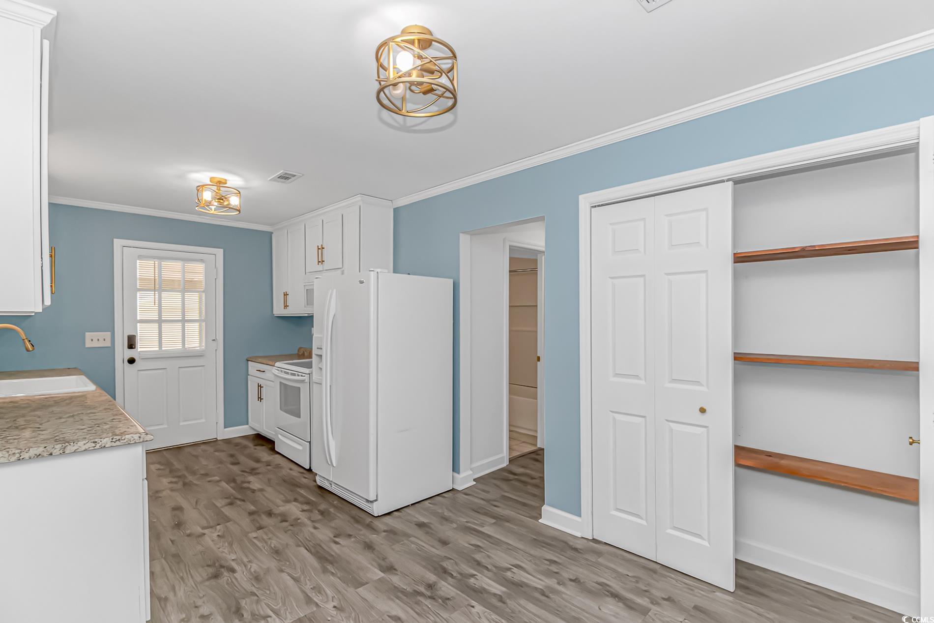 1931 Jasper Street Georgetown, SC 29440 - Photo 10 of 30 Kitchen with white cabinetry, crown molding, light