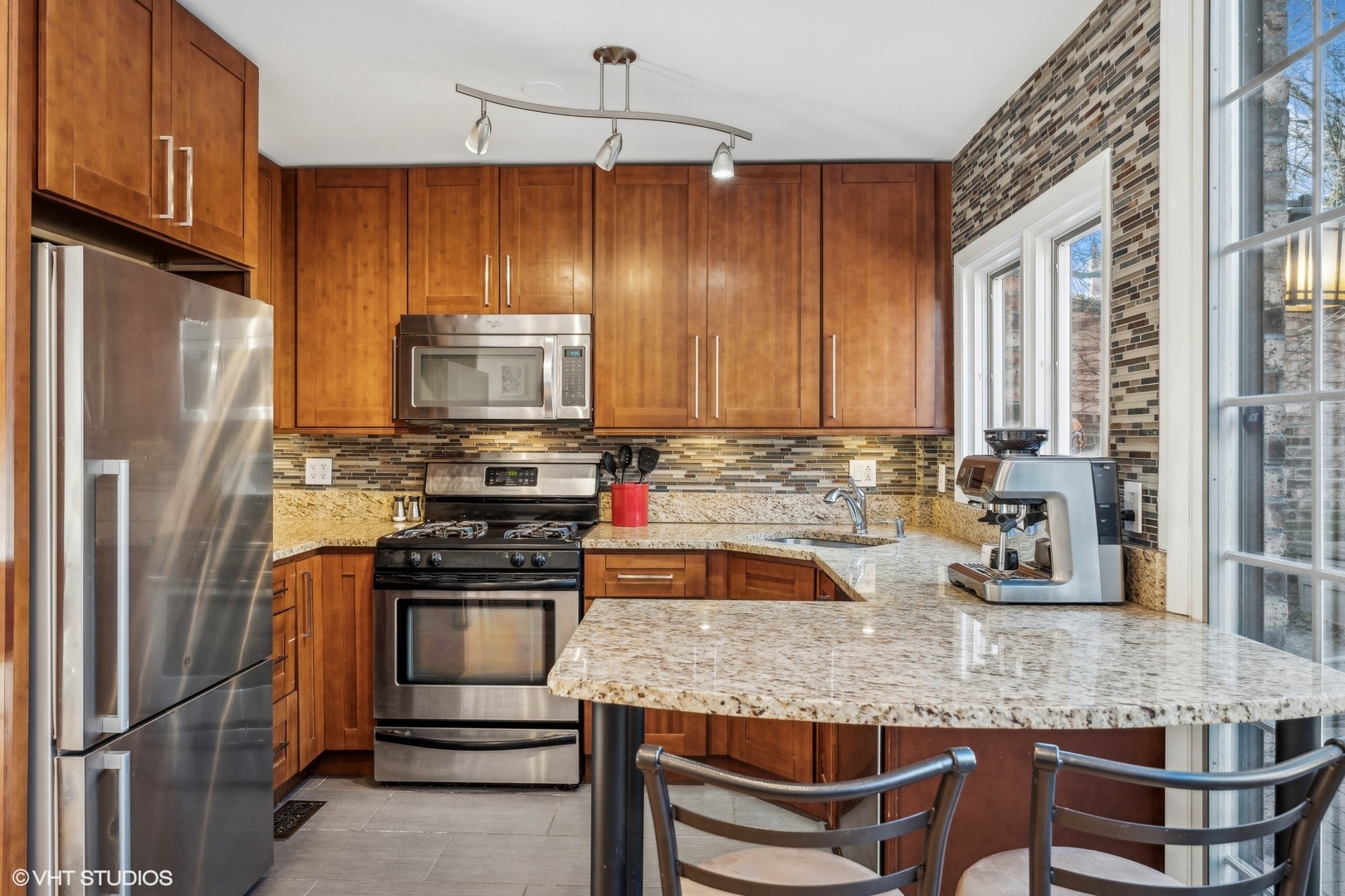 2701 North Racine Avenue, Unit A Chicago, IL 60614 - Photo 7 of 25 a kitchen with granite countertop a stove refrigerator and microwave