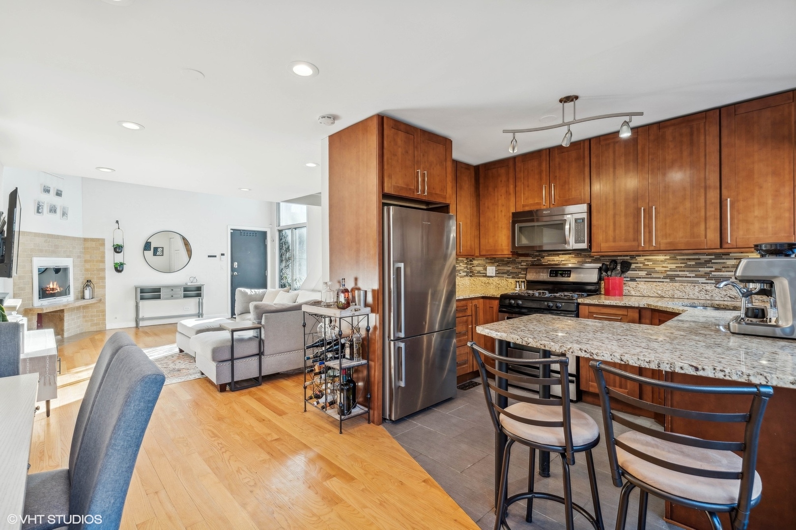2701 North Racine Avenue, Unit A Chicago, IL 60614 - Photo 9 of 25 a kitchen with granite countertop a refrigerator stove microwave and cabinets