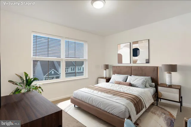 a bedroom with a large bed and a potted plant