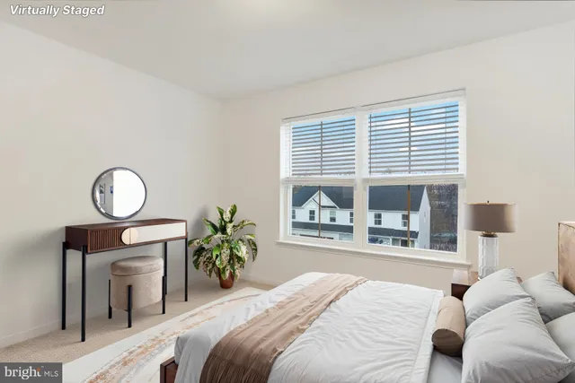 a bedroom with a large bed and a window