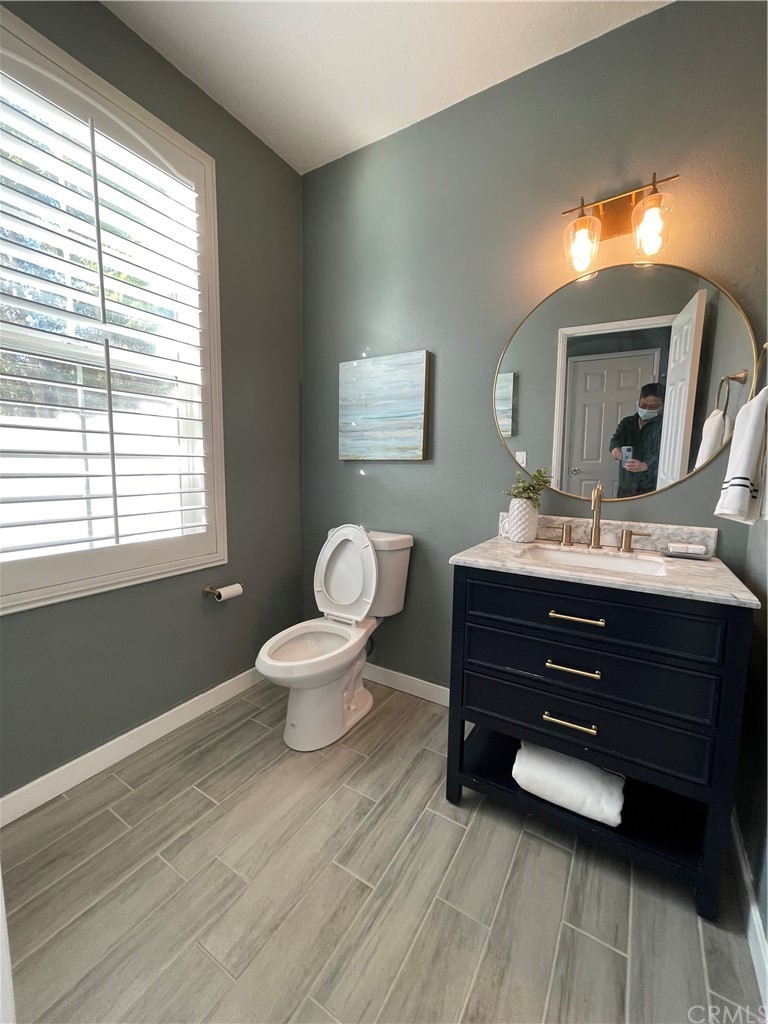 21 Thorp Ladera Ranch Ladera Ranch, CA 92694 - Photo 12 of 15 a bathroom with a toilet a sink and a mirror