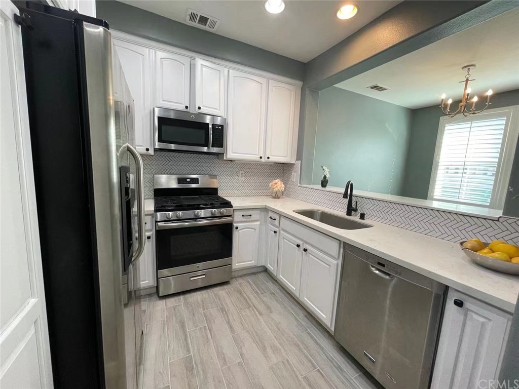21 Thorp Ladera Ranch Ladera Ranch, CA 92694 - Photo 15 of 15 a kitchen with a sink stove and microwave