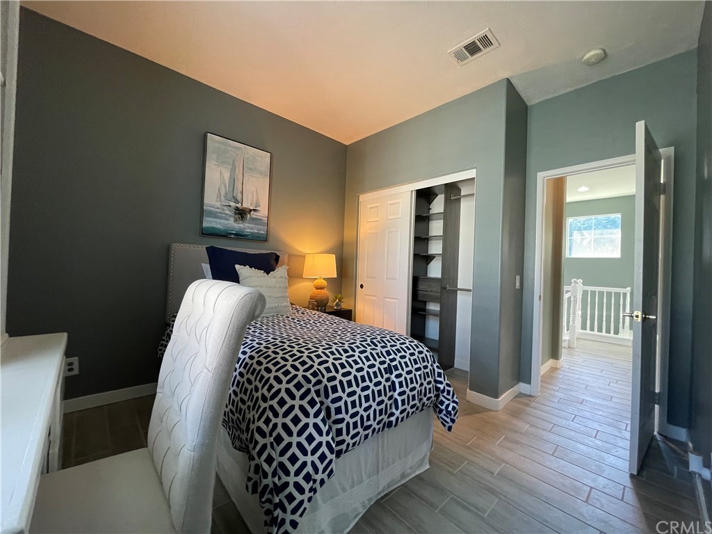 21 Thorp Ladera Ranch Ladera Ranch, CA 92694 - Photo 9 of 15 a bedroom with a bed and wooden floor