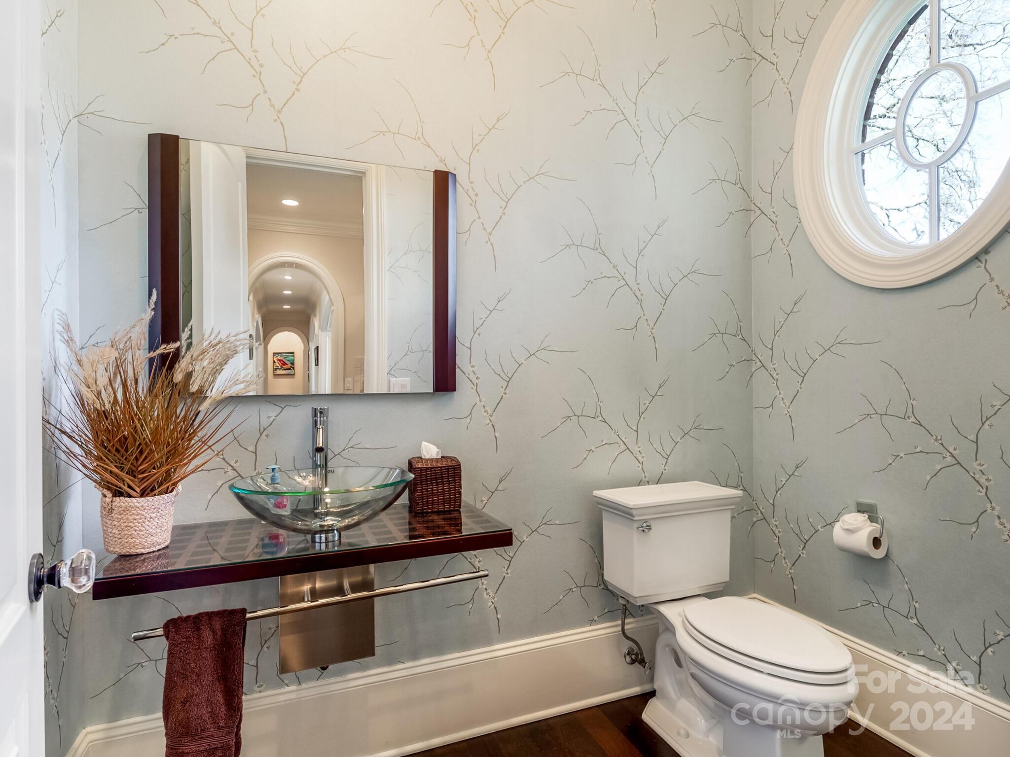 1271 Andover Road Charlotte, NC 28211 - Photo 17 of 40 a bathroom with a toilet a sink and mirror