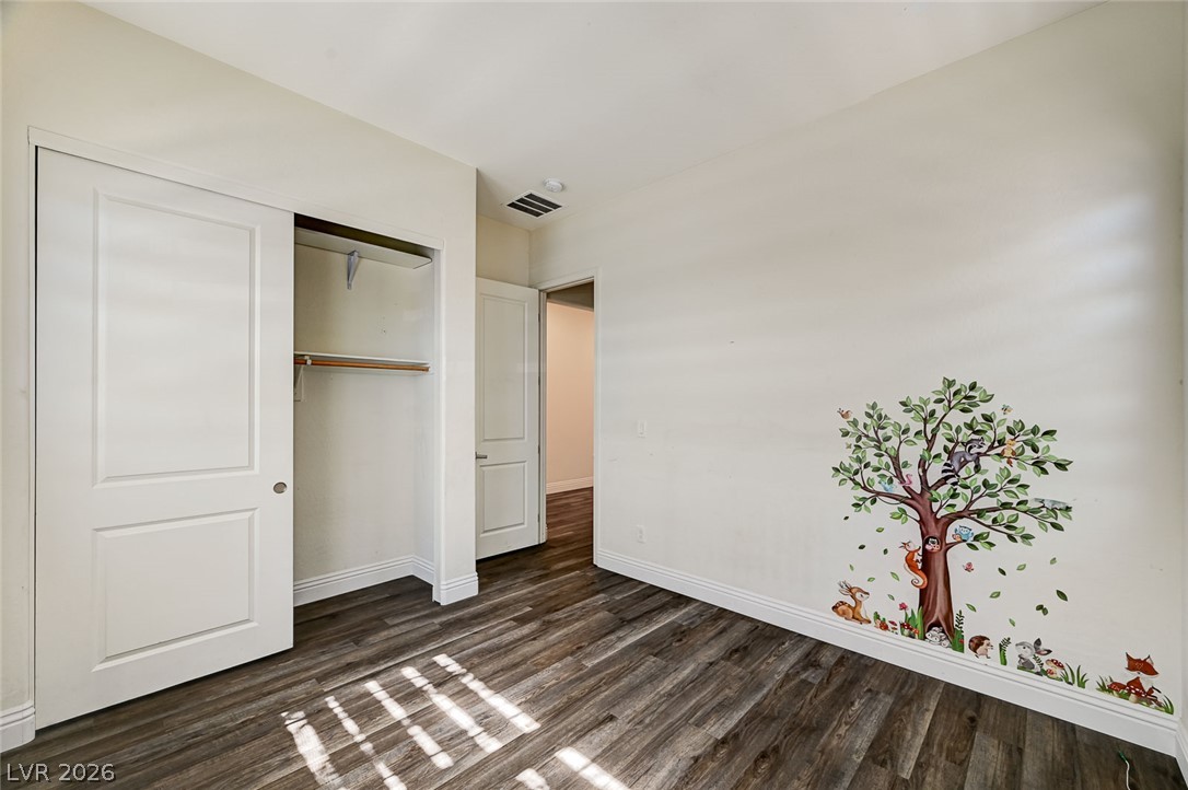 8197 Riley Love Street Las Vegas, NV 89139 - Photo 6 of 48 Well-lit interior featuring durable wood flooring and ample closet space.