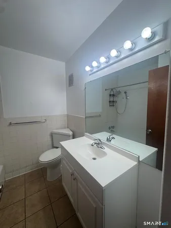 a bathroom with a sink toilet and mirror