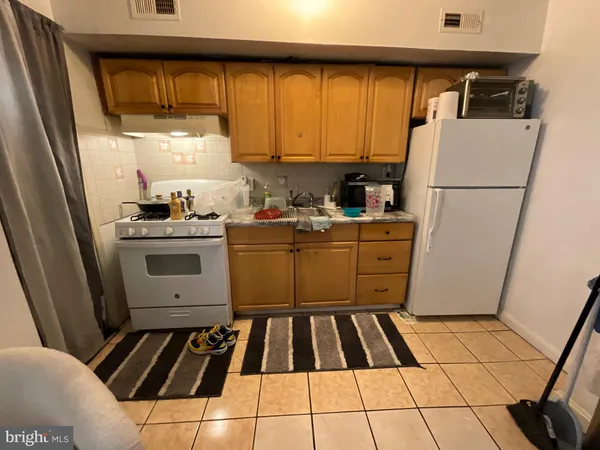 a kitchen with a cabinets and white appliances