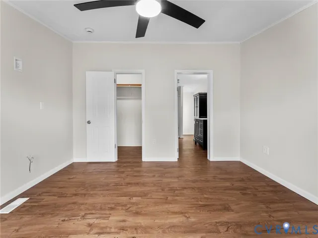 a view of an empty room with wooden floor