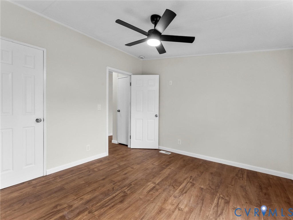 4772 Carsley Road Waverly, VA 23890 - Photo 25 of 38 an empty room with wooden floor and ceiling fan