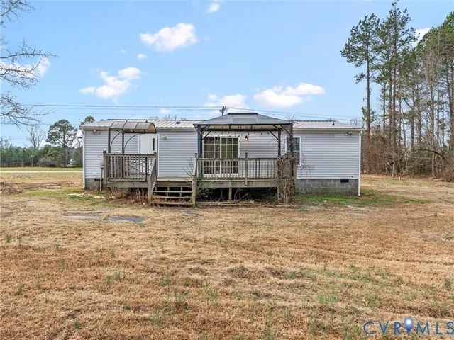 a view of a balcony with wooden floor and fence