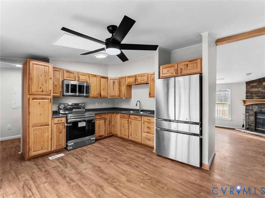 4772 Carsley Road Waverly, VA 23890 - Photo 6 of 38 a kitchen with stainless steel appliances granite countertop a refrigerator microwave and stove top oven