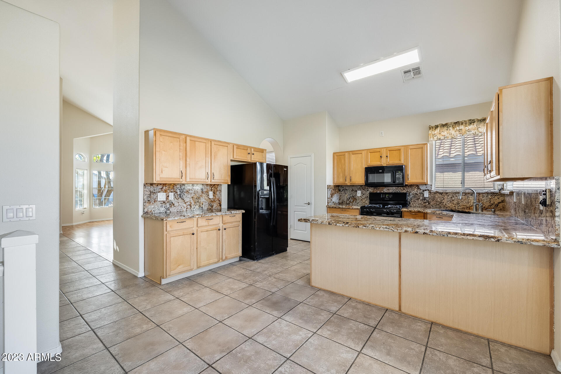 3244 West Maldonado Road Phoenix, AZ 85041 - Photo 15 of 43 a kitchen with stainless steel appliances a refrigerator sink and microwave