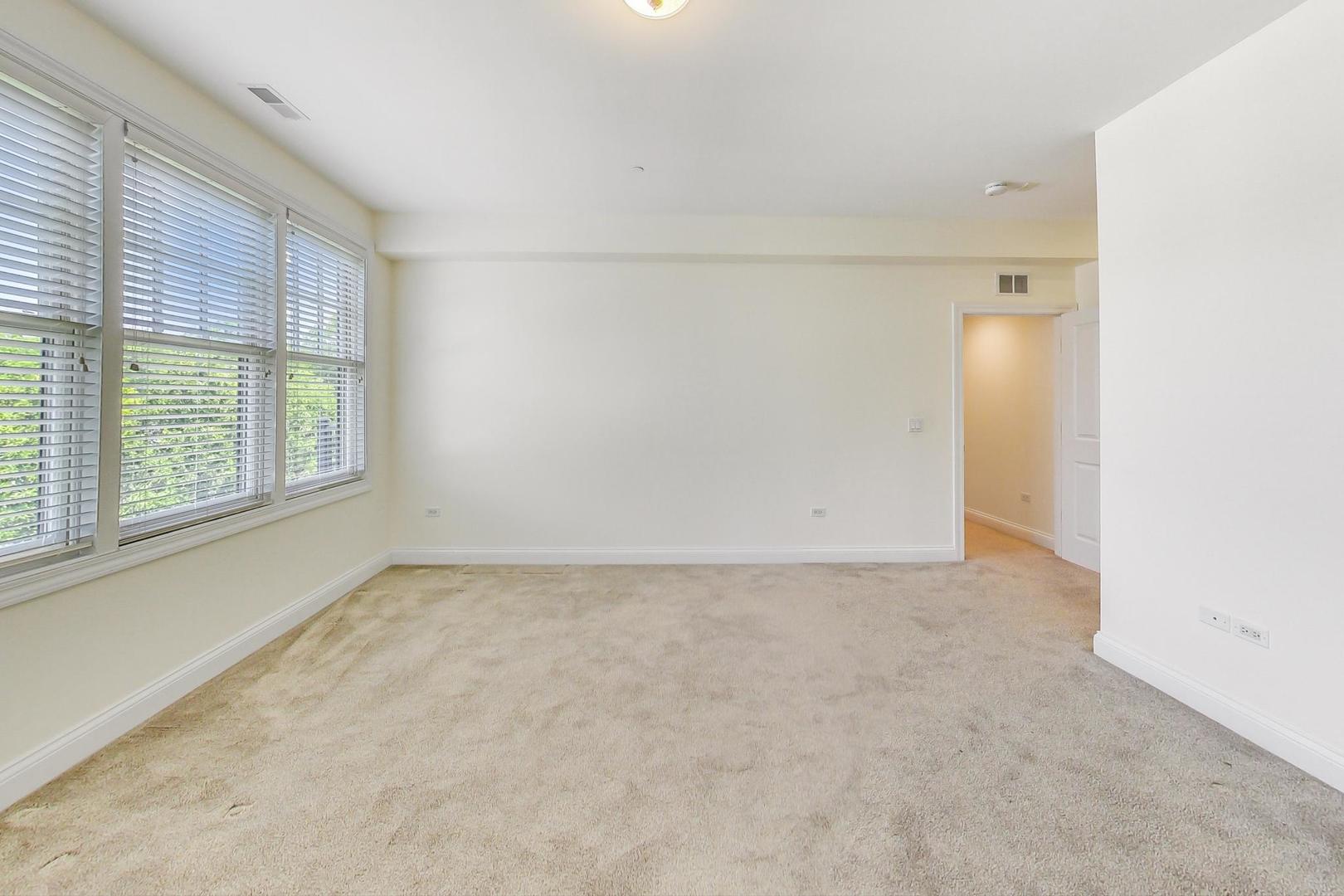 720 Green Bay Road, Unit 2D Winnetka, IL 60093 - Photo 16 of 41 an empty room with windows and closet
