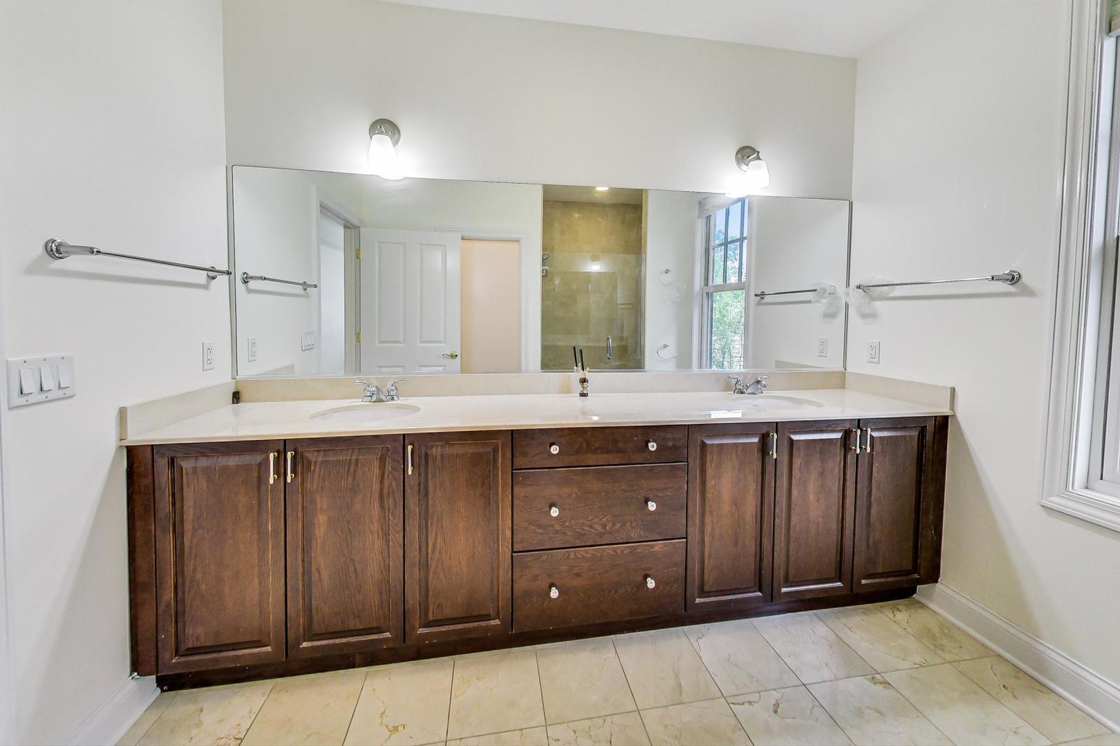 720 Green Bay Road, Unit 2D Winnetka, IL 60093 - Photo 20 of 41 a bathroom with a sink vanity and mirror