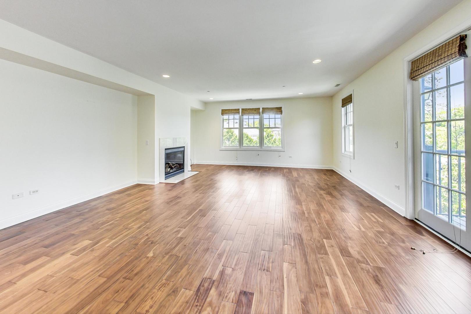 720 Green Bay Road, Unit 2D Winnetka, IL 60093 - Photo 3 of 41 an empty room with wooden floor and windows