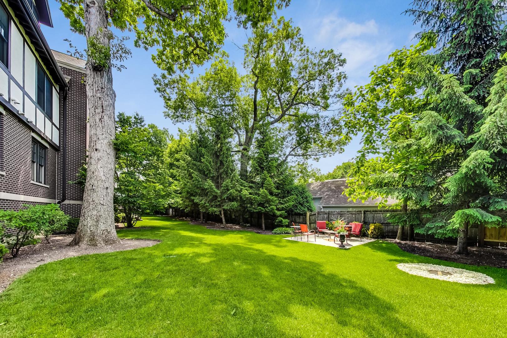 720 Green Bay Road, Unit 2D Winnetka, IL 60093 - Photo 37 of 41 a view of an house with swimming pool garden and trees