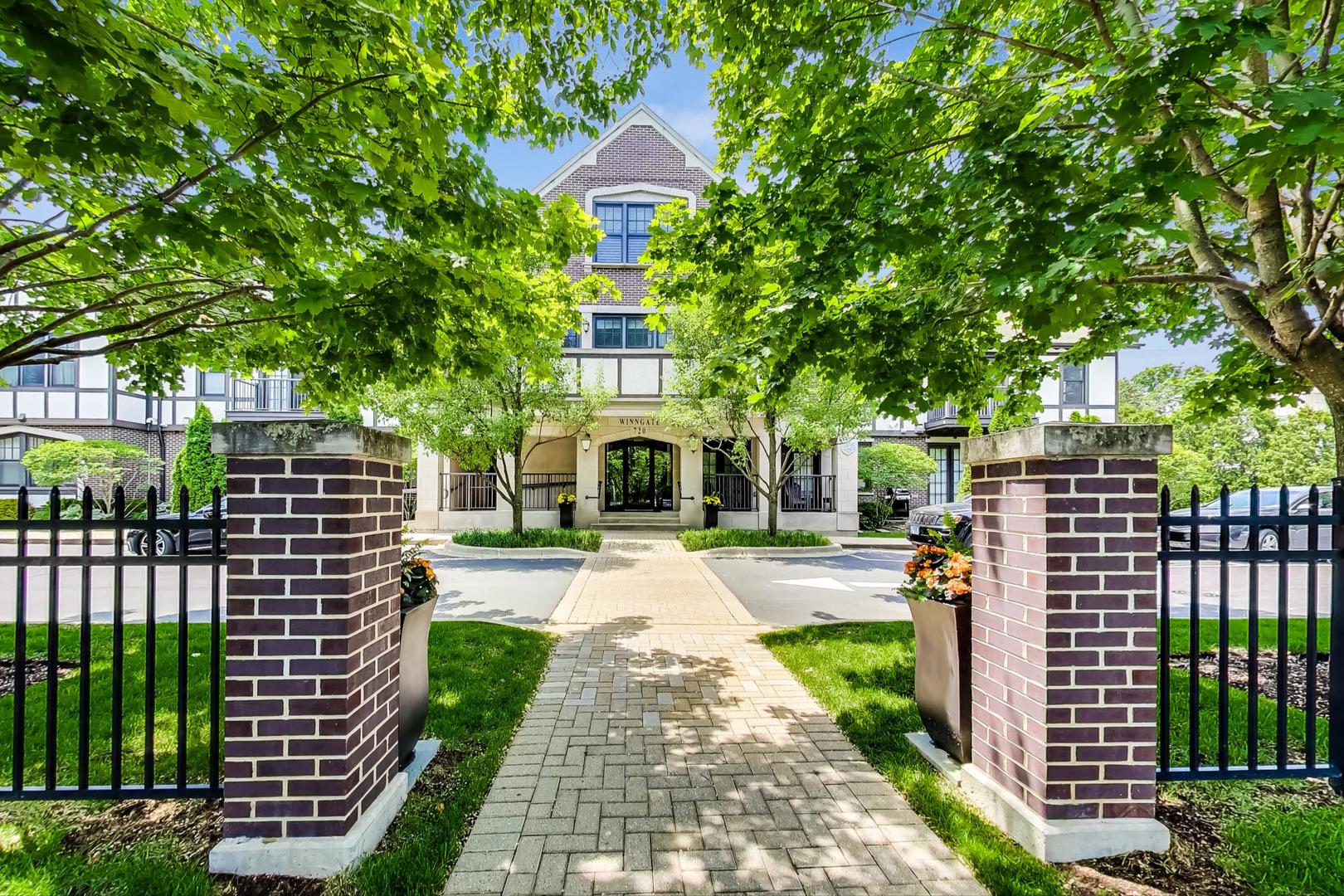 720 Green Bay Road, Unit 2D Winnetka, IL 60093 - Photo 39 of 41 a front view of a house with a yard and fountain