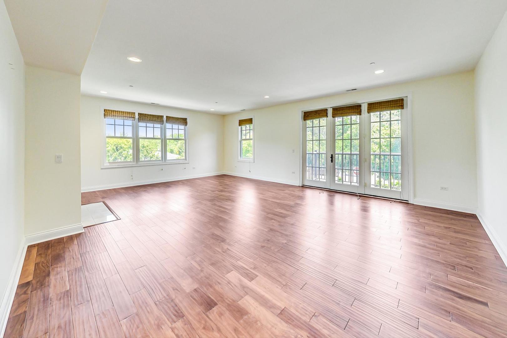 720 Green Bay Road, Unit 2D Winnetka, IL 60093 - Photo 4 of 41 a view of an empty room with wooden floor and a window