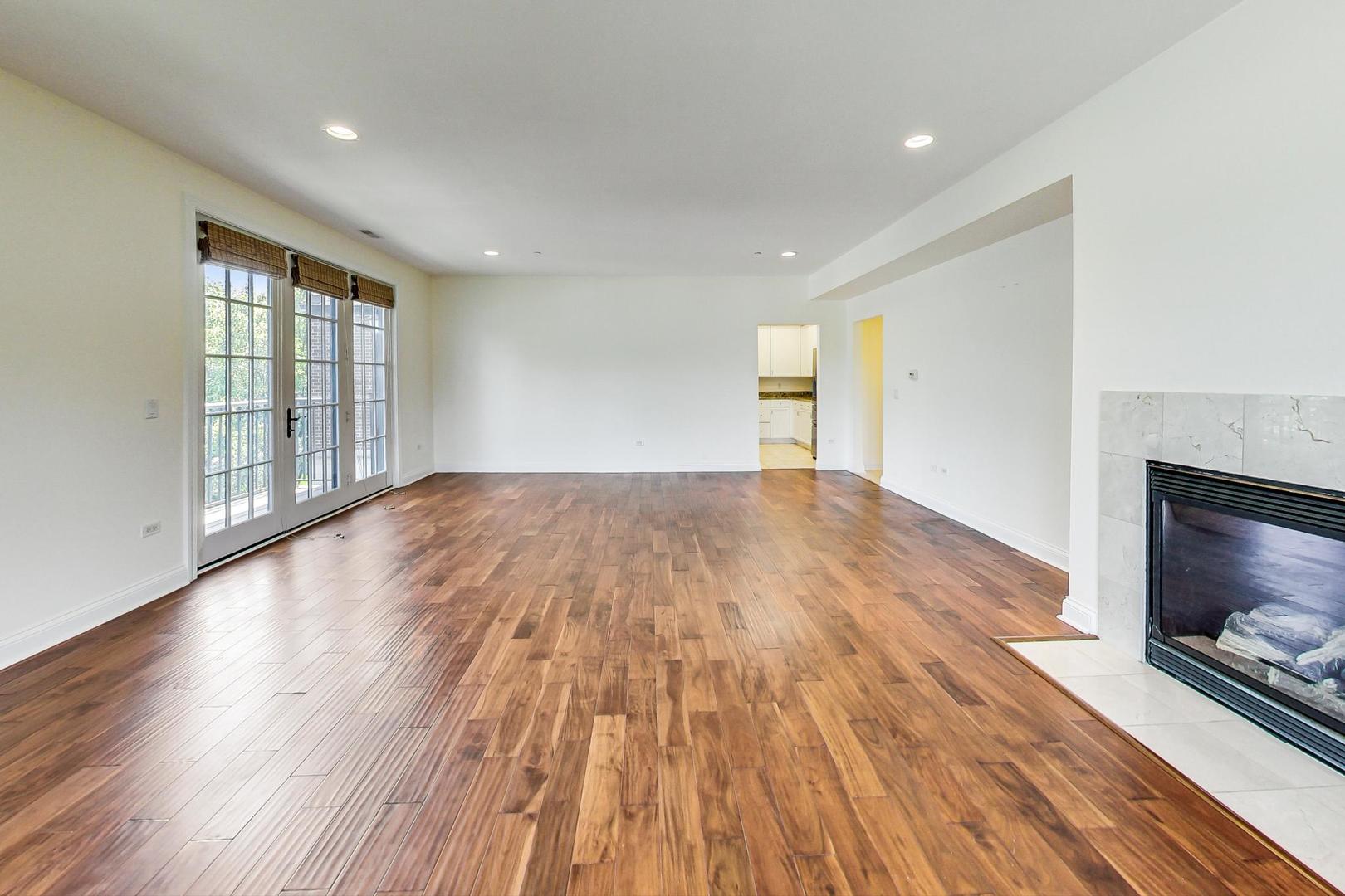 720 Green Bay Road, Unit 2D Winnetka, IL 60093 - Photo 7 of 41 a view of an empty room with wooden floor and a window