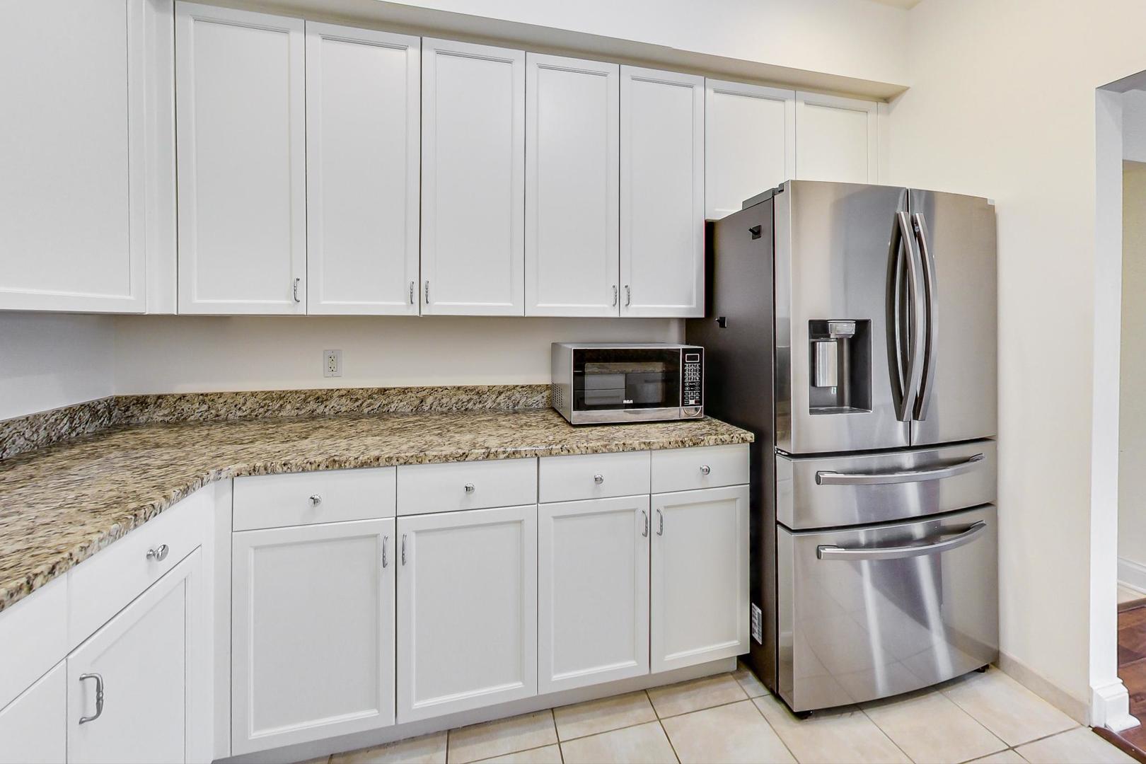 720 Green Bay Road, Unit 2D Winnetka, IL 60093 - Photo 10 of 41 a kitchen with stainless steel appliances granite countertop a refrigerator a stove and white cabinets