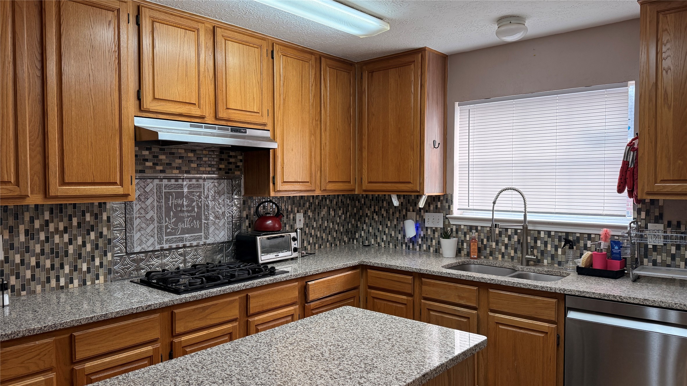 10310 Hedge Way Drive Houston, TX 77065 - Photo 5 of 17 a kitchen with granite countertop a sink a stove and cabinets