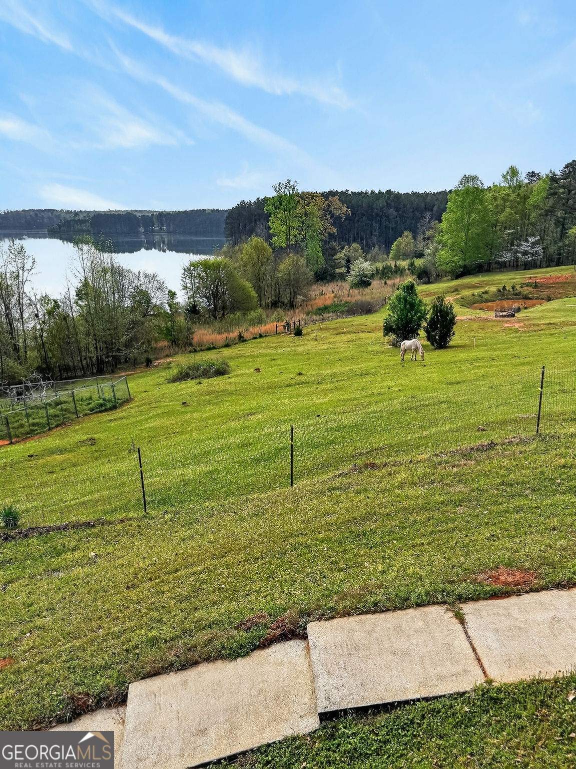 955 Mocassin Gap Road Locust Grove, GA 30248 - Photo 49 of 59 a view of a golf course with a lake