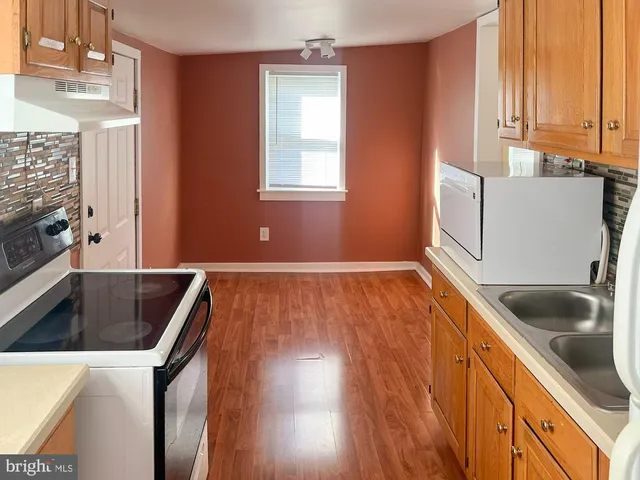 a kitchen that has a sink and a stove