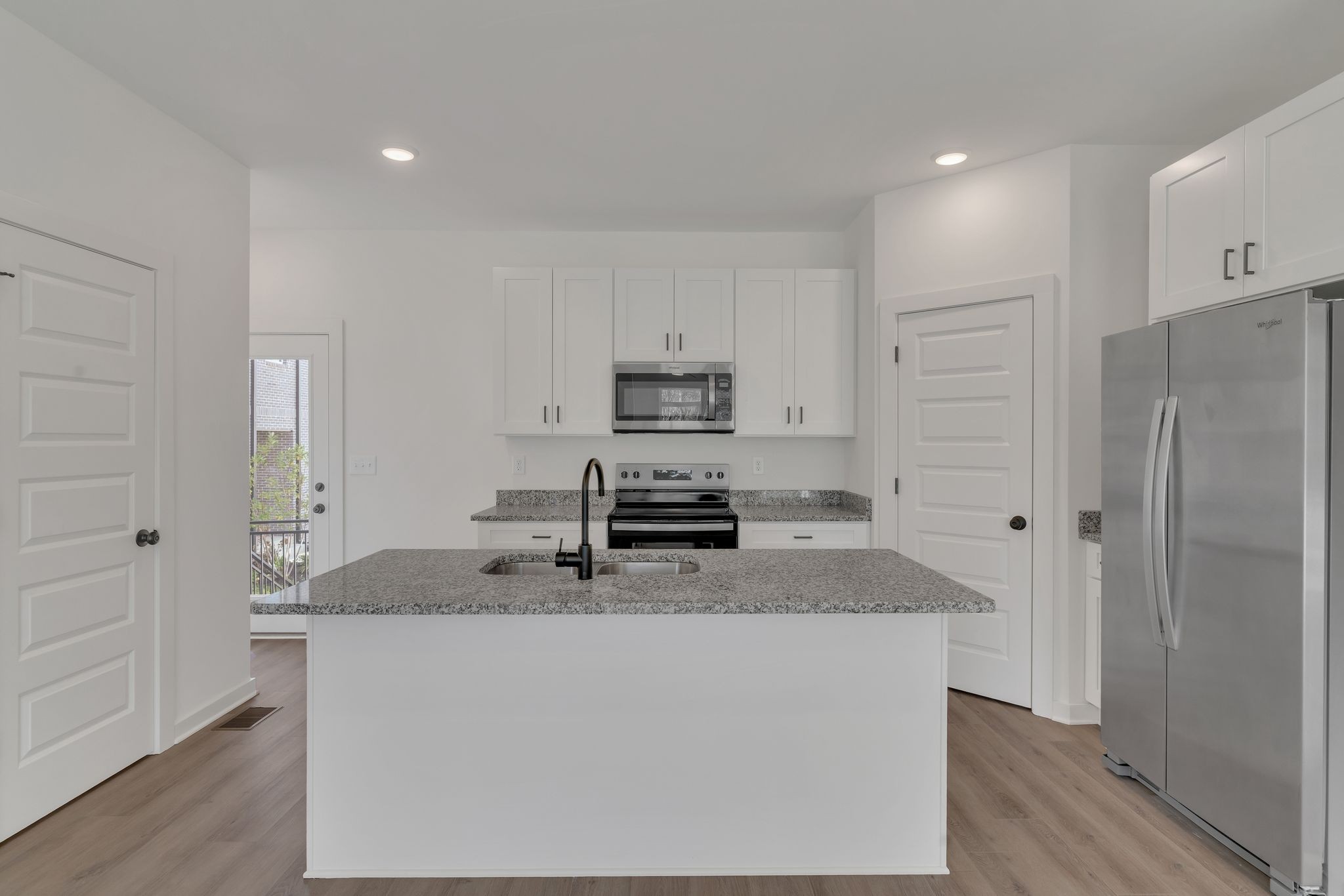 308 Cedar Street, Unit 2 Lebanon, TN 37087 - Photo 11 of 28 a kitchen with granite countertop a refrigerator and a sink