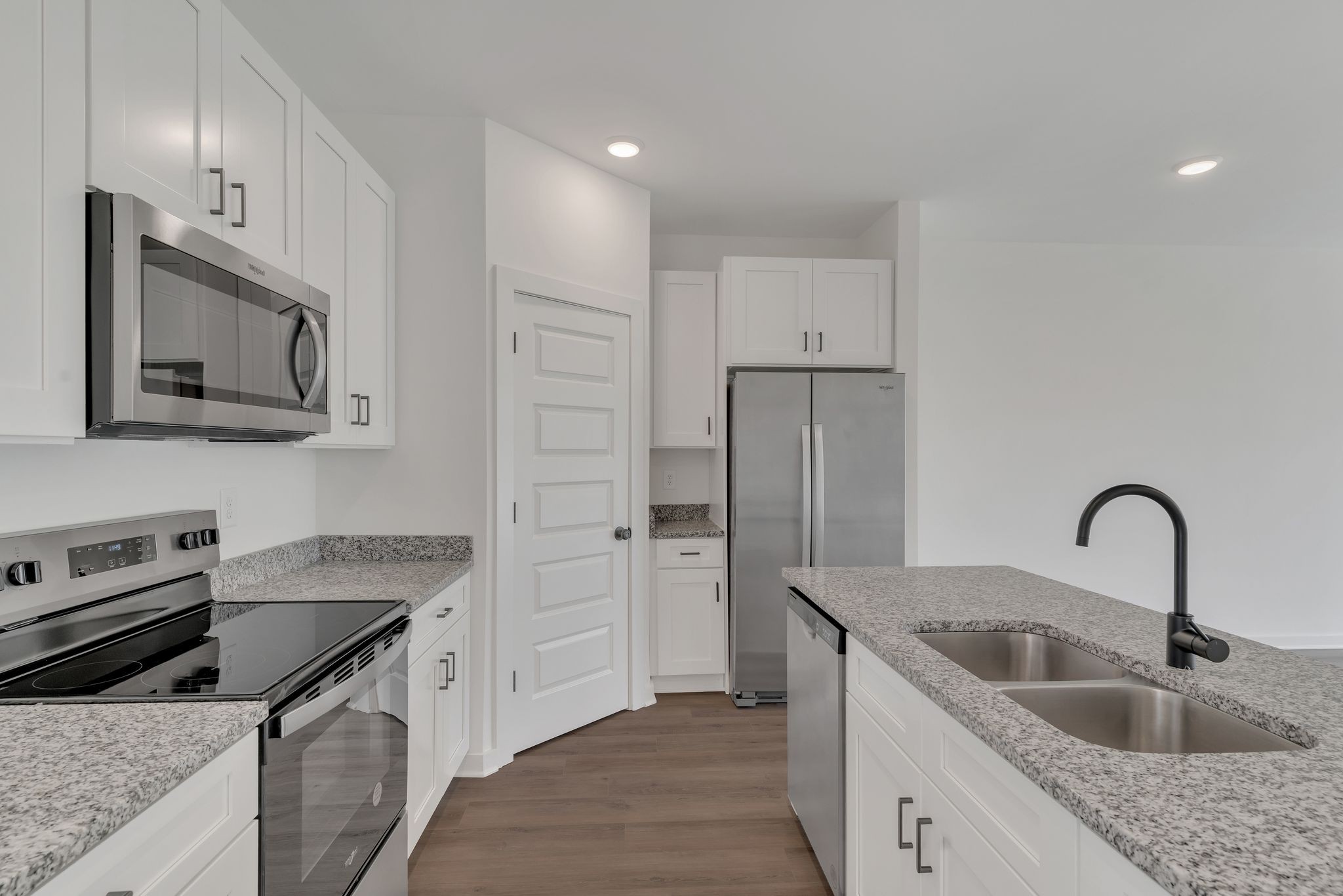 308 Cedar Street, Unit 2 Lebanon, TN 37087 - Photo 12 of 28 a kitchen with stainless steel appliances granite countertop a sink stove and refrigerator