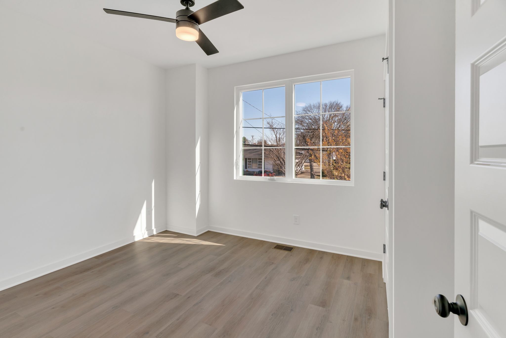 308 Cedar Street, Unit 2 Lebanon, TN 37087 - Photo 14 of 28 a view of empty room with wooden floor and fan