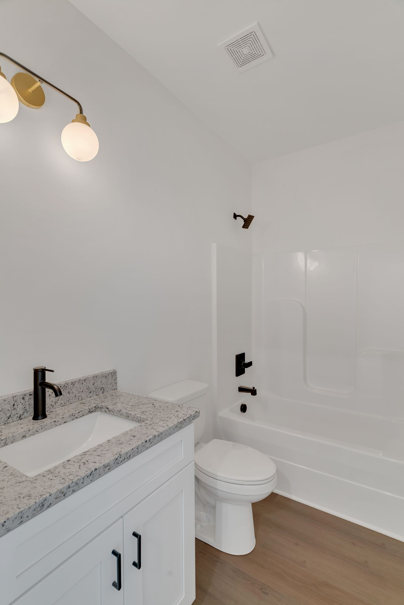 308 Cedar Street, Unit 2 Lebanon, TN 37087 - Photo 24 of 28 a bathroom with a granite countertop sink a toilet and shower
