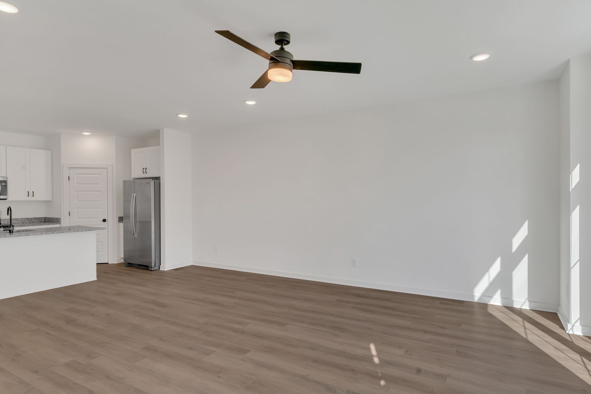 308 Cedar Street, Unit 2 Lebanon, TN 37087 - Photo 7 of 28 a view of an empty room with wooden floor and a window