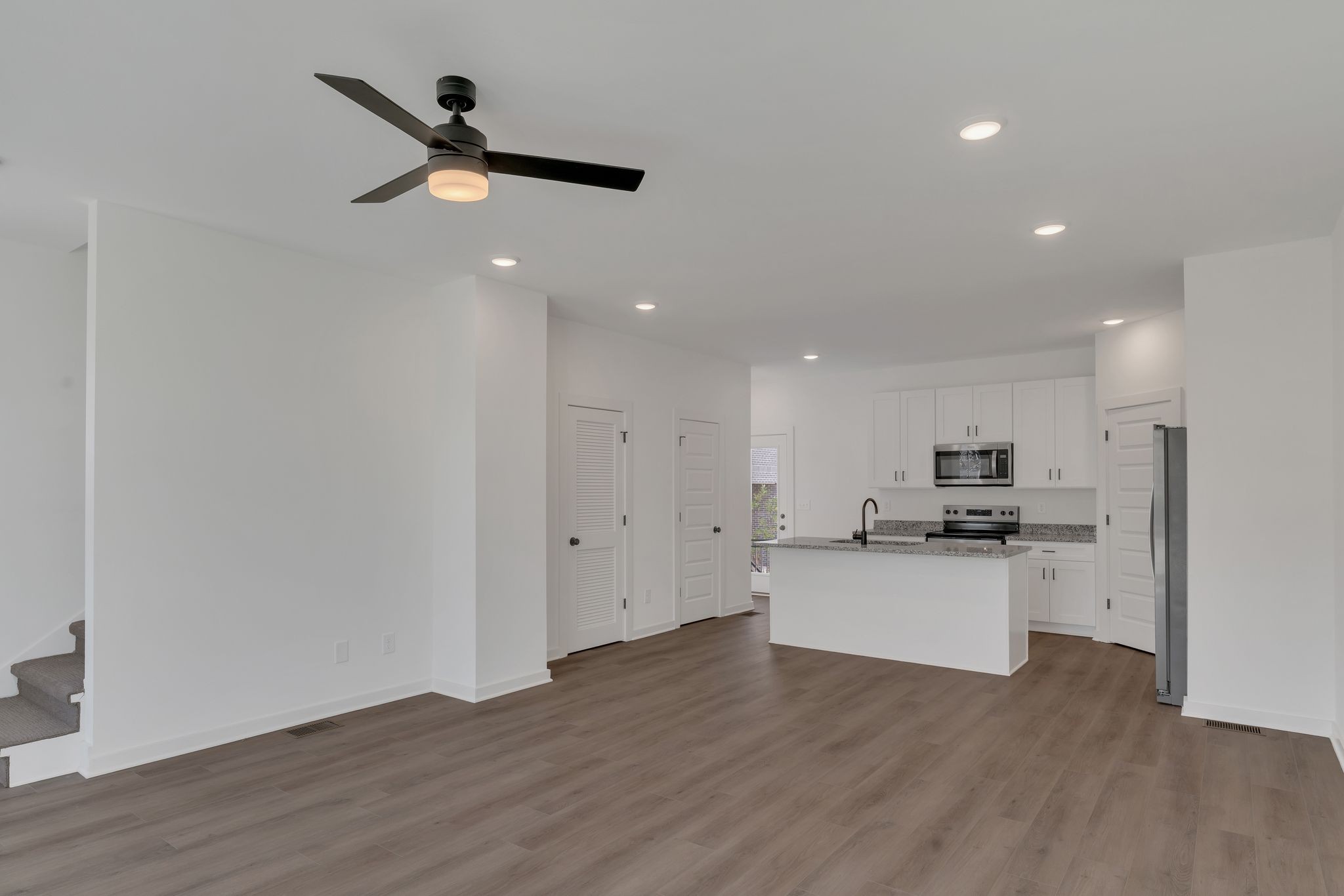 308 Cedar Street, Unit 2 Lebanon, TN 37087 - Photo 9 of 28 a kitchen with a refrigerator and white cabinets