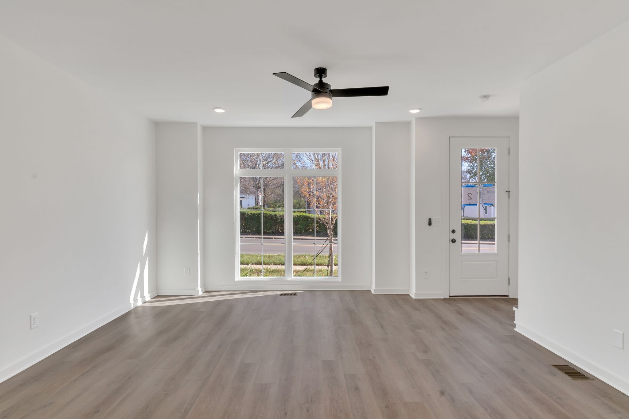308 Cedar Street, Unit 2 Lebanon, TN 37087 - Photo 10 of 28 an empty room with wooden floor and windows