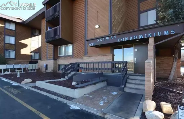 a view of a patio with couches table and chairs with wooden floor and fence