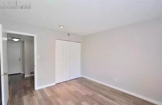 a view of an empty room and wooden floor