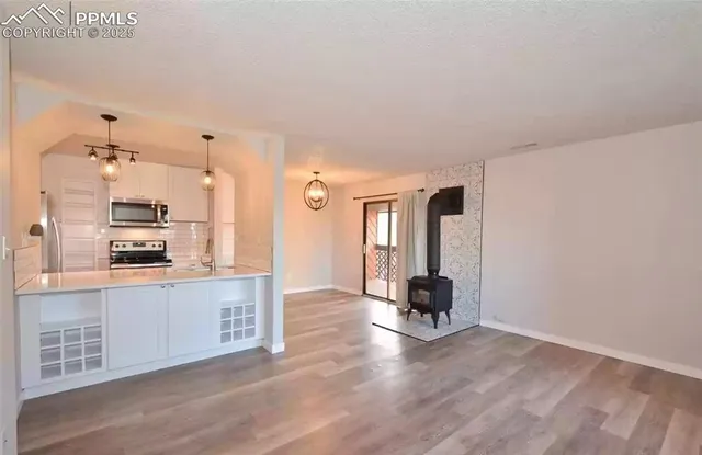 a room with furniture and kitchen view