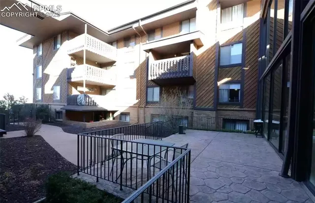 a living room with couches and painted walls with wooden floor