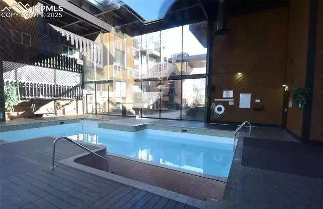 a view of a house with a mountain and a forest