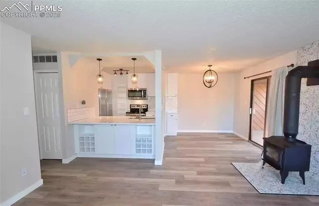 a view of kitchen with granite countertop window and a sink