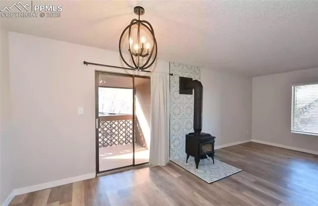 a living room with wooden floor and gym equipment